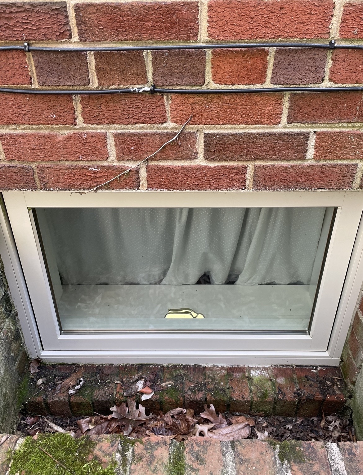 Same basement window after cleaning — frame and glass spotless